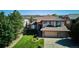 Beautiful home with a well-manicured lawn, mature trees, and an attached three car garage at 1328 Double Eagle Ct, Castle Rock, CO 80104