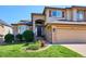 Charming home featuring stone accents, a well-kept lawn and garden at 1328 Double Eagle Ct, Castle Rock, CO 80104