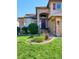 Charming home featuring brick accents, a manicured lawn, and an arched doorway at 1328 Double Eagle Ct, Castle Rock, CO 80104