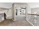 Hallway view with a glimpse into a living room featuring a fireplace, high ceilings, and large windows at 1328 Double Eagle Ct, Castle Rock, CO 80104
