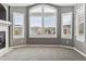 Living room featuring large windows with white shutters, carpeted floors, and a fireplace at 1328 Double Eagle Ct, Castle Rock, CO 80104