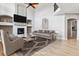 Cozy living room with a fireplace, high ceilings, and hardwood floors at 1328 Double Eagle Ct, Castle Rock, CO 80104
