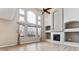 Bright living room featuring a high ceiling, large windows, and fireplace with custom shelving at 1328 Double Eagle Ct, Castle Rock, CO 80104