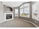 Living room featuring a fireplace and large windows with white shutters at 1328 Double Eagle Ct, Castle Rock, CO 80104