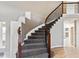 Grand staircase with iron railings and a hardwood floor landing area at 1328 Double Eagle Ct, Castle Rock, CO 80104