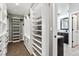 Large walk-in closet with custom shelving and storage solutions, located just off the main bathroom at 1328 Double Eagle Ct, Castle Rock, CO 80104