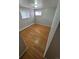 Light-filled bedroom showcasing hardwood floors and two bright windows at 387 Tucson St, Aurora, CO 80011