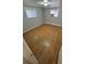 Inviting bedroom features refinished hardwood floors, neutral paint, and two windows at 387 Tucson St, Aurora, CO 80011