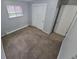 Bedroom with carpeting and a closet with sliding doors with light from a window at 387 Tucson St, Aurora, CO 80011