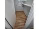 Walk-in closet or pantry featuring wood-look flooring and built-in shelving at 387 Tucson St, Aurora, CO 80011