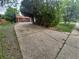 Long concrete driveway leading up to a well-maintained brick home with mature trees at 387 Tucson St, Aurora, CO 80011