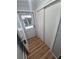Bright entryway with wood-look floors, a sliding closet, and a storm door leading outside at 387 Tucson St, Aurora, CO 80011