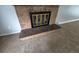 Close-up of brick fireplace with tile accents and a decorative metal screen at 387 Tucson St, Aurora, CO 80011