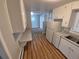 Clean kitchen with laminate flooring, white cabinets, and modern appliances at 387 Tucson St, Aurora, CO 80011