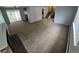 Large living room with carpeting, fireplace, sliding glass doors, and staircase access at 387 Tucson St, Aurora, CO 80011