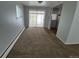 View of living room with carpeting, sliding glass doors, and access to kitchen area at 387 Tucson St, Aurora, CO 80011