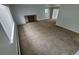 Inviting living room with a brick fireplace, soft carpeting, and sliding glass doors at 387 Tucson St, Aurora, CO 80011