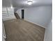 Large living room with carpeted floors, built-in shelving, and stairway access at 387 Tucson St, Aurora, CO 80011
