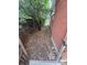 Narrow side yard with gravel, a wooden fence, and a brick house at 387 Tucson St, Aurora, CO 80011