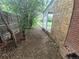 Narrow side yard with dirt, a wooden fence, and a brick house at 387 Tucson St, Aurora, CO 80011