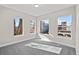 Bedroom featuring three large windows letting in light, neutral paint, and plush carpet at 2140 S Ash St # 101, Denver, CO 80222
