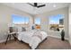 Bright bedroom boasting large windows, modern ceiling fan, and comfortable decor at 2140 S Ash St # 101, Denver, CO 80222