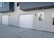 Modern townhome garages with individual doors and sleek design, providing convenient parking at 2140 S Ash St # 101, Denver, CO 80222