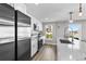 Bright kitchen features stainless steel appliances, a modern faucet, and bright windows offering city views at 2140 S Ash St # 101, Denver, CO 80222