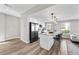 Open concept kitchen with an island, bar stools, stainless steel appliances, and lots of natural light at 2140 S Ash St # 101, Denver, CO 80222