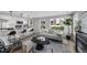 Cozy living room featuring a modern kitchen, fireplace, comfortable seating, and city views at 2140 S Ash St # 101, Denver, CO 80222