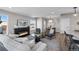 Comfortable living room featuring a fireplace, modern decor, and open layout to the kitchen and dining areas at 2140 S Ash St # 101, Denver, CO 80222
