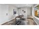 Bright office features wood floors, natural light from the window, a modern desk, and a stylish accent rug at 2140 S Ash St # 101, Denver, CO 80222