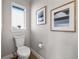 Compact powder room featuring a modern toilet, decorative art, and neutral color scheme at 2140 S Ash St # 101, Denver, CO 80222