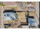 Top-down aerial view of a house with a spacious backyard on a sunny day, showcasing trees casting shadows and neighboring houses at 4710 Pennsylvania St, Denver, CO 80216