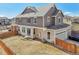 Backyard view featuring a fenced yard, patio and exterior of the home at 21411 E 60Th Ave, Aurora, CO 80019