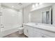 Bathroom with white tile shower, vanity and modern fixtures at 21411 E 60Th Ave, Aurora, CO 80019