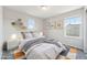 Bright bedroom with a white bed frame, natural light, and a stylish rug on a gray carpet at 21411 E 60Th Ave, Aurora, CO 80019