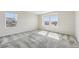 Bright bedroom featuring carpet, fresh paint, and natural light from two windows at 21411 E 60Th Ave, Aurora, CO 80019
