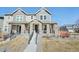 A stunning view of the two-story home featuring stone accents and landscaped front yard at 21411 E 60Th Ave, Aurora, CO 80019