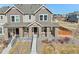Exterior elevation of the house, showing the front porch, landscaping and neighborhood at 21411 E 60Th Ave, Aurora, CO 80019