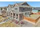 Exterior of home showcasing the yard, architectural details, and landscaping at 21411 E 60Th Ave, Aurora, CO 80019