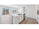 Kitchen island with stainless steel sink and dishwasher, open to dining area and sliding door at 21411 E 60Th Ave, Aurora, CO 80019