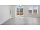 Bright living room with sliding glass doors and large windows overlooking the backyard at 21411 E 60Th Ave, Aurora, CO 80019