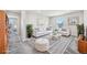 Bright living room with white furniture, modern decor, and a large window offering natural light at 21411 E 60Th Ave, Aurora, CO 80019