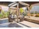 Charming backyard patio features covered area, cozy seating, and privacy landscaping at 8378 Arapahoe Peak St, Littleton, CO 80125