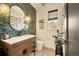 Stylish powder room features green subway tiles, wooden vanity, and modern fixtures at 8378 Arapahoe Peak St, Littleton, CO 80125