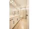 Bright bathroom featuring modern vanity, neutral tiling, and a shower with a tub at 8378 Arapahoe Peak St, Littleton, CO 80125