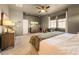 Cozy bedroom showcasing a soft carpet, TV, dresser, and large window at 8378 Arapahoe Peak St, Littleton, CO 80125