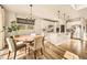 Bright eat-in kitchen with white cabinetry, stainless appliances and stylish pendant lighting at 8378 Arapahoe Peak St, Littleton, CO 80125