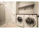 Functional laundry room equipped with modern appliances and storage at 8378 Arapahoe Peak St, Littleton, CO 80125